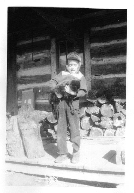 On the family farm in the winter with my cat named Stack.